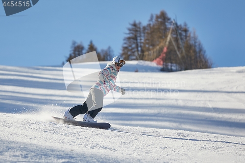 Image of Female snowboarder on the slope