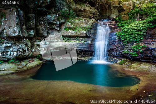 Image of Waterfall into a rock pool deep in the wilderness