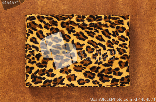 Image of Storage box with leopard print on leather background