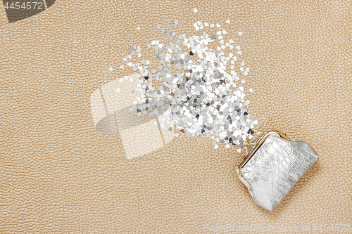Image of Glitter hearts pouring out of a silver purse