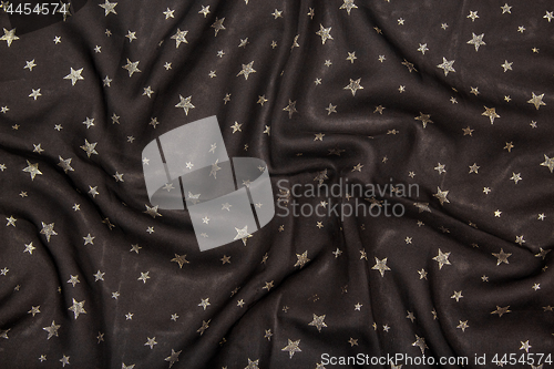 Image of Black silky fabric with glittering metallic stars