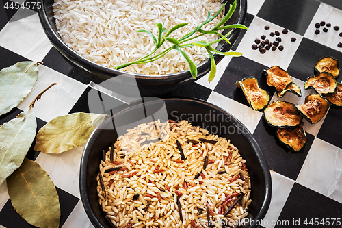 Image of Rice and spices on checked kitchen counter