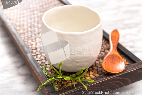 Image of Ceramic teacup on a wooden tray