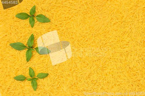 Image of Fresh basil leaves decorating noodles background