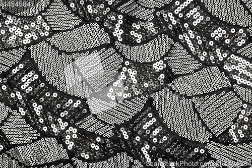 Image of Black fabric with shiny silver sequin design