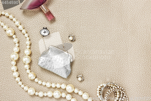 Image of Silver purse, jewelry and perfume