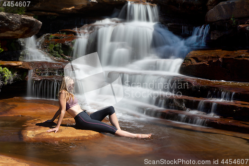 Image of Relaxing in the sunshine by a tranquil waterfall
