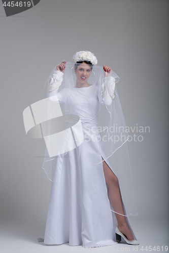 Image of young bride in a wedding dress with a veil