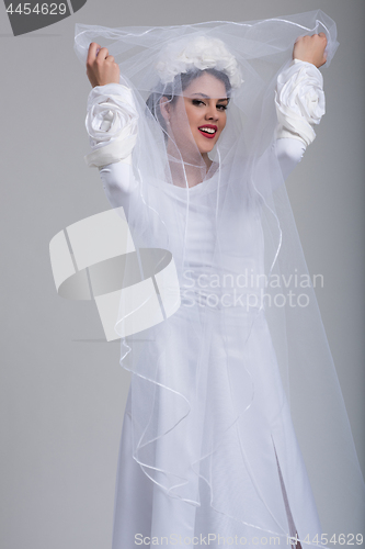 Image of young bride in a wedding dress with a veil