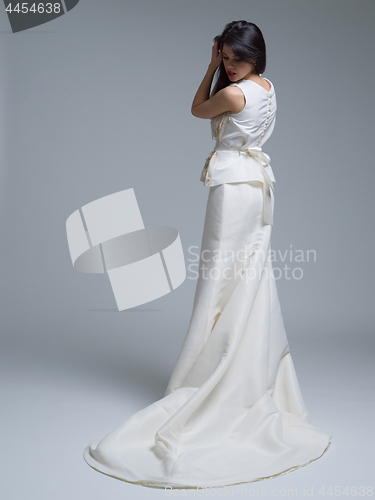 Image of Rear view of a beautiful young woman in a wedding dress