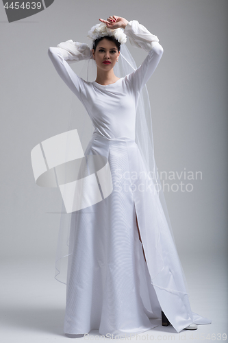 Image of young bride in a wedding dress with a veil