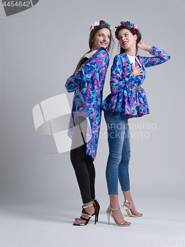 Image of two Fashion Model girls isolated over white background