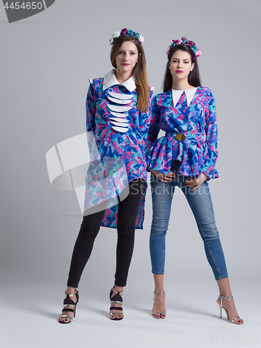 Image of two Fashion Model girls isolated over white background