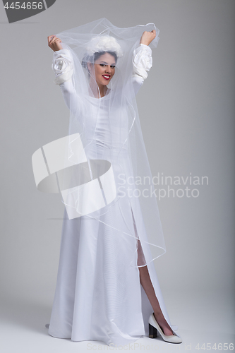 Image of young bride in a wedding dress with a veil