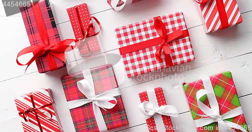 Image of Top view of wrapped Christmas presents laid on the wooden table