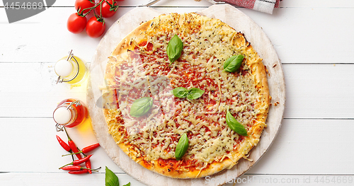 Image of Delicious italian pizza served on wooden table, shot from above