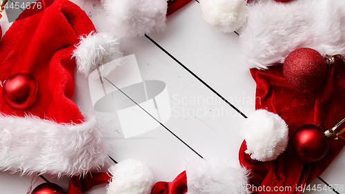 Image of Santa Claus hats on white wooden desk with blank copy space.