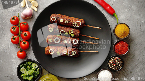 Image of Barbecued turkey kebab decorated with fresh onion