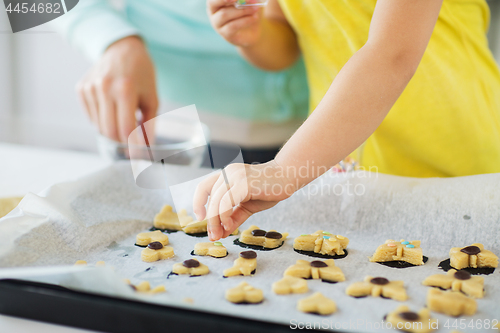 Image of mother and daughter making cookies at home