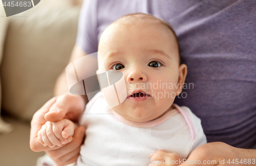 Image of close up of father with little baby girl at home