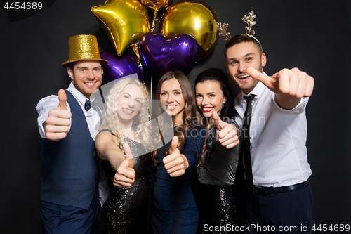 Image of friends at christmas party showing thumbs up