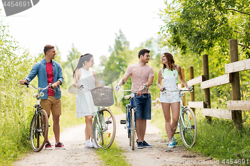 Image of happy friends with fixed gear bicycles in summer