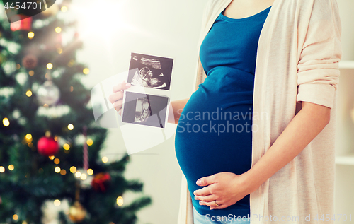 Image of pregnant woman with ultrasound images at christmas