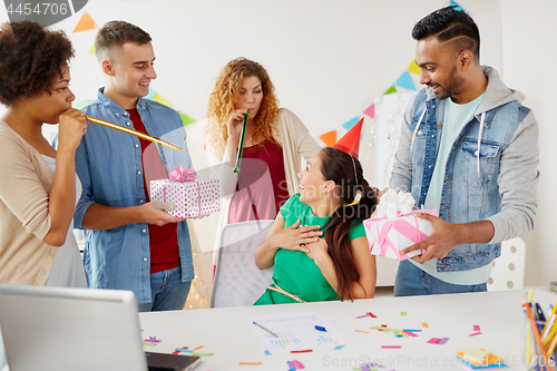 Image of team greeting colleague at office birthday party