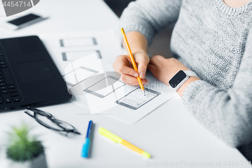 Image of web designer working on user interface at office