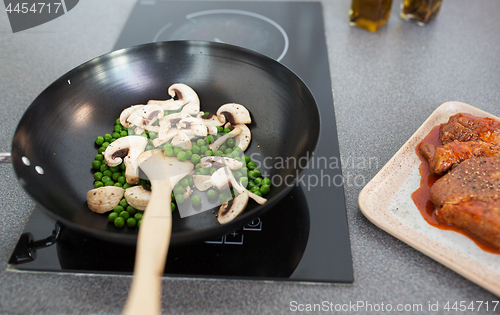 Image of close up of food in frypan on cooking panel