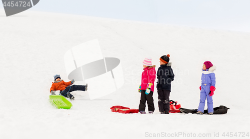 Image of happy little kids with sleds in winter