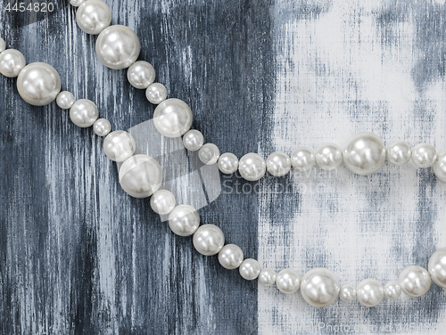 Image of Pearl necklace on gray artistic background