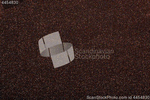 Image of Texture of golden metallic threads in black fabric