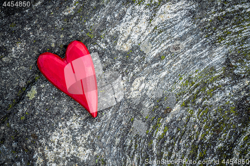 Image of Red heart on mossy rock background