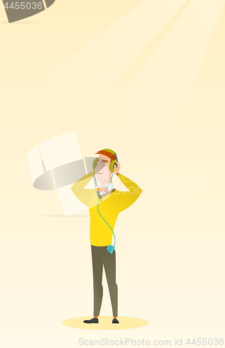 Image of Young man in headphones listening to music.