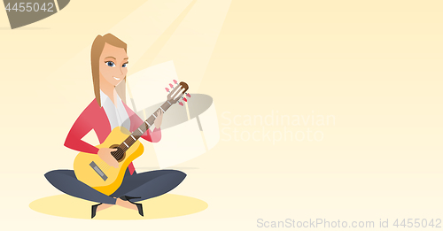 Image of Woman playing the acoustic guitar.