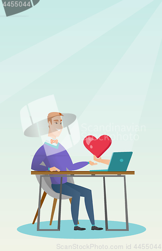 Image of Young man using a laptop online dating.