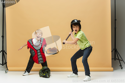 Image of Two happy children show different sport. Studio fashion concept. Emotions concept.