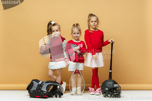 Image of Happy and beautyful children show different sport. Studio fashion concept. Emotions concept.