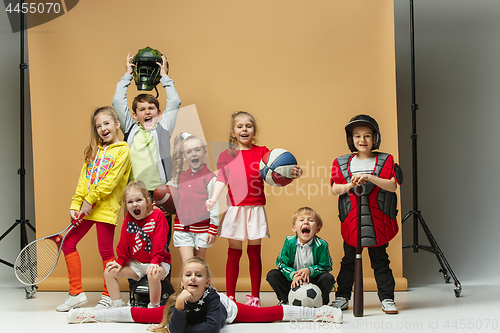 Image of Group of happy children show different sport. Studio fashion concept. Emotions concept.