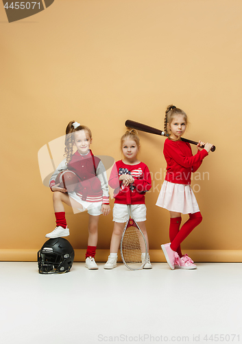 Image of Happy and beautyful children show different sport. Studio fashion concept. Emotions concept.