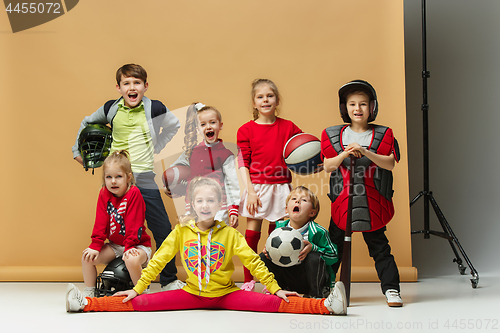 Image of Group of happy children show different sport. Studio fashion concept. Emotions concept.