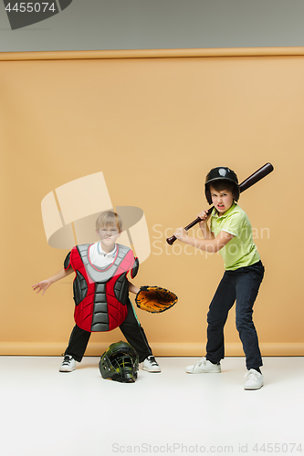 Image of Two happy children show different sport. Studio fashion concept. Emotions concept.