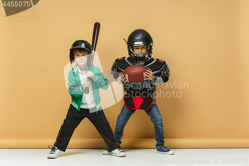 Image of Two happy children show different sport. Studio fashion concept. Emotions concept.