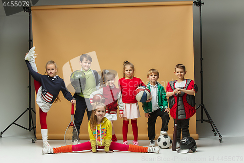 Image of Group of happy children show different sport. Studio fashion concept. Emotions concept.