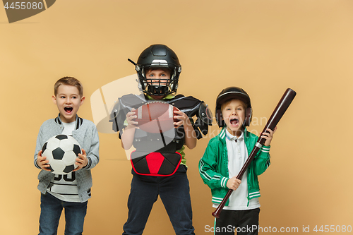 Image of Three happy children show different sport. Studio fashion concept. Emotions concept.