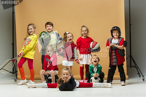 Image of Group of happy children show different sport. Studio fashion concept. Emotions concept.