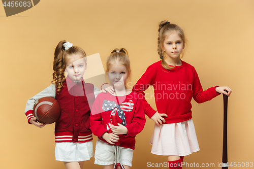 Image of Happy and beautyful children show different sport. Studio fashion concept. Emotions concept.