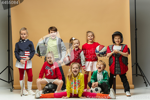 Image of Group of happy children show different sport. Studio fashion concept. Emotions concept.