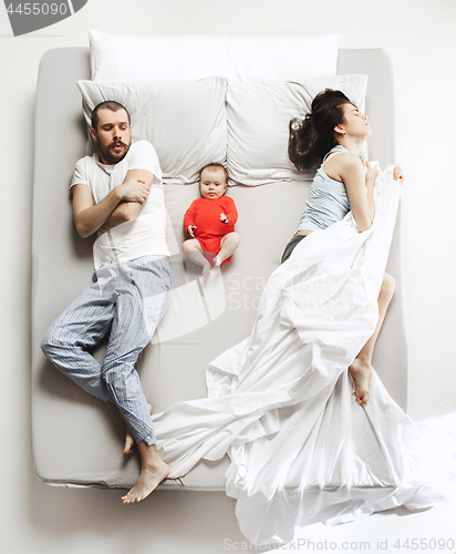 Image of Top view of happy family with one newborn child in bedroom.